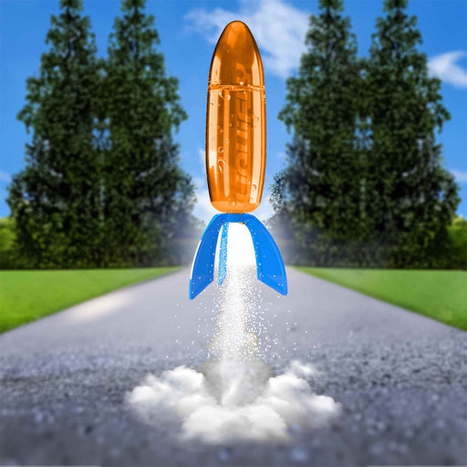 Toy rocket launching on a road with trees in the background