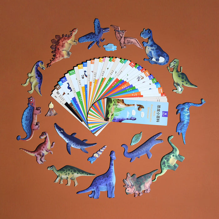 Colorful toy dinosaurs arranged around a fan of cards on an orange background