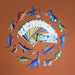 Colorful toy dinosaurs arranged around a fan of cards on an orange background