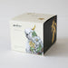 Decorative box with a cockatoo illustration and brand name on a white background