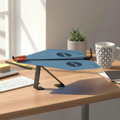 Blue adjustable desk stand on a wooden desk with a mug and stationery items.