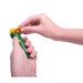 Hand holding a green and yellow toy with a white background