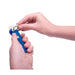 Hand holding a blue and white tool against a white background