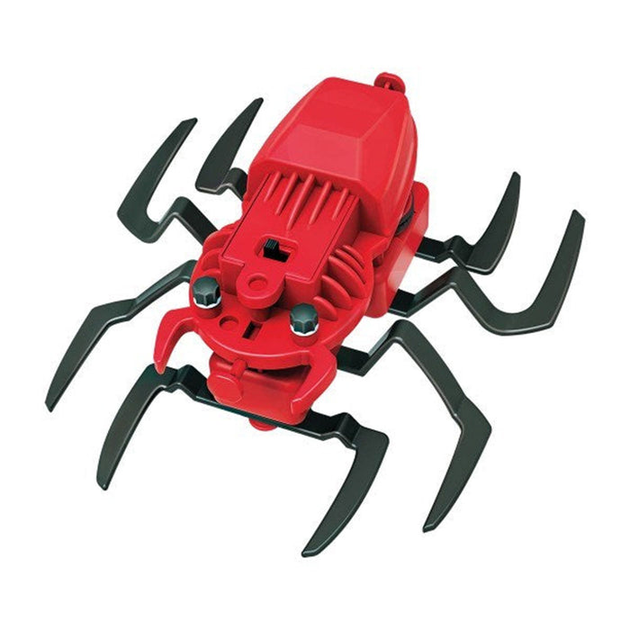 Red toy spider with black legs on a white background
