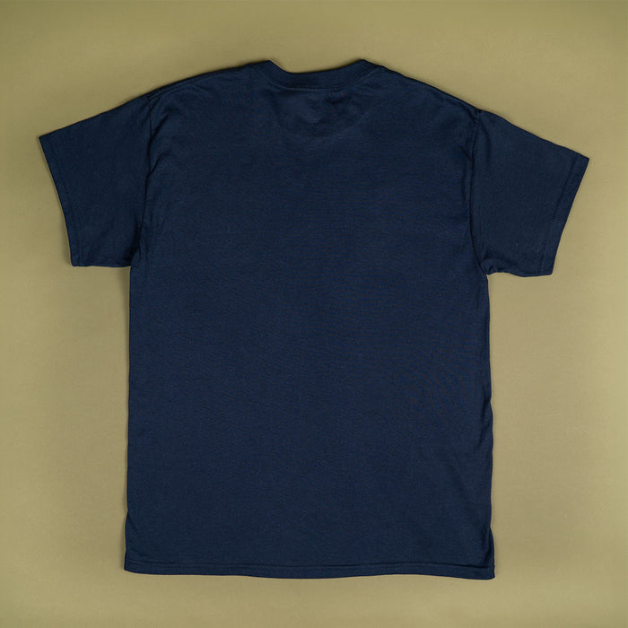 A plain navy blue short-sleeve t-shirt laid flat against a solid beige background.