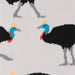 Close-up of a knit fabric with a repeating pattern of black cassowellas featuring bright blue, red, yellow, and gray details on a light background.