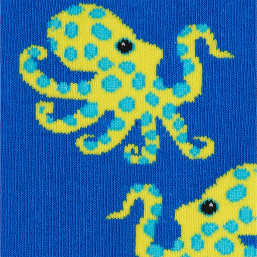 Close-up of a blue sock with a yellow octopus design on a blue background