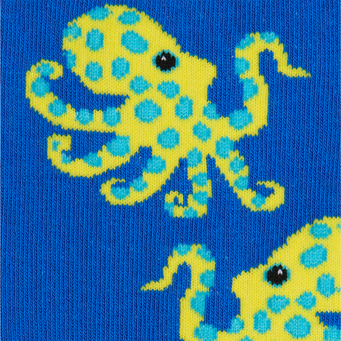 Close-up of a blue sock with a yellow octopus design on a blue background