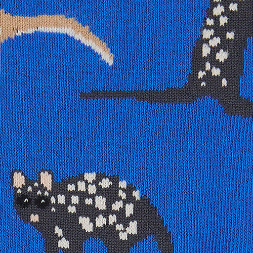 Close-up of a sock with a pattern of a quoll on a blue background.