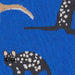 Close-up of a sock with a pattern of a quoll on a blue background.