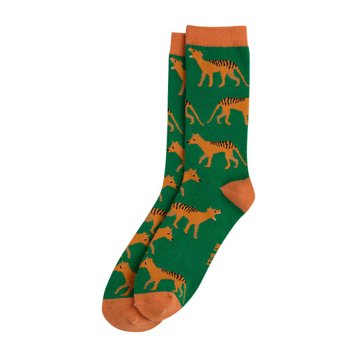 A pair of crew socks with a green background featuring an allover pattern of orange and black striped Tasmanian tigers, finished with solid orange cuffs, heels, and toes.