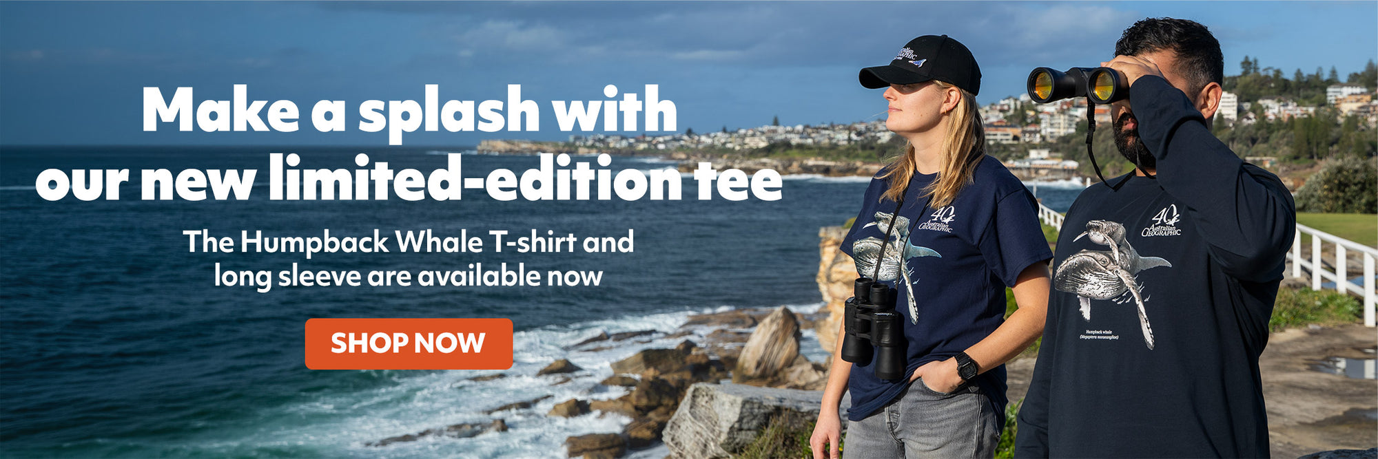 Promotional banner featuring two people wearing matching navy blue Humpback Whale T-shirts on a rocky coastal path by the ocean, with large white marketing text and an orange 'SHOP NOW' button.