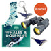 Collection of whale-themed items including socks, binoculars, and keychains on a white background.