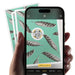 A hand holds a smartphone showing a camera interface with a feather pattern and a QR code, with two matching patterned cards fanned behind it on a white background.