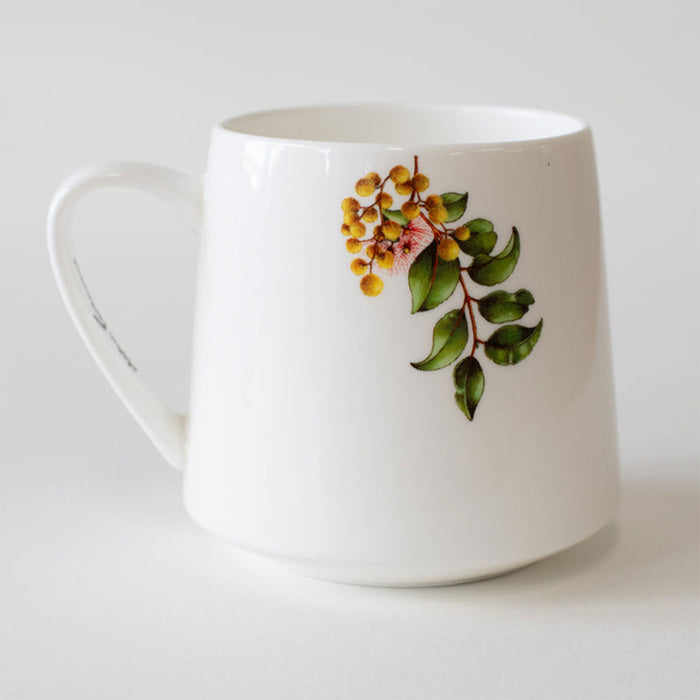 White mug with floral design on a white background