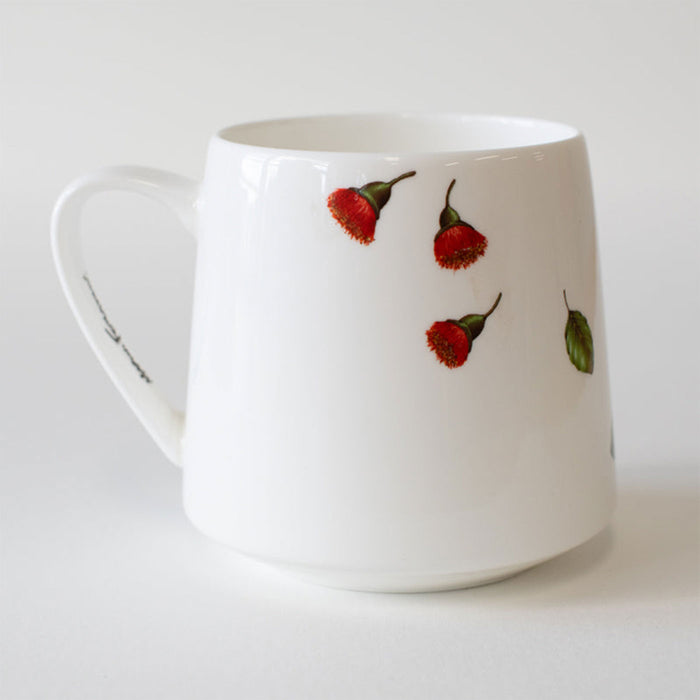 White mug with red floral design on a white background